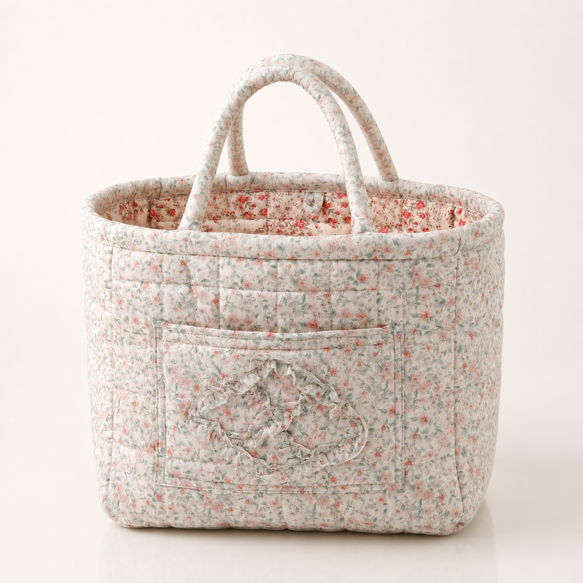 Quilted cotton storage basket with handles and front pocket