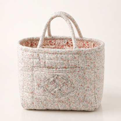 Quilted cotton storage basket with handles and front pocket