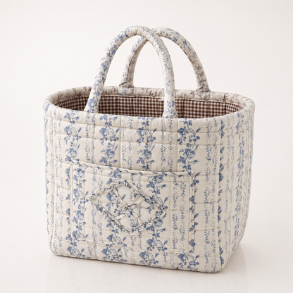 Quilted cotton storage basket with handles and front pocket
